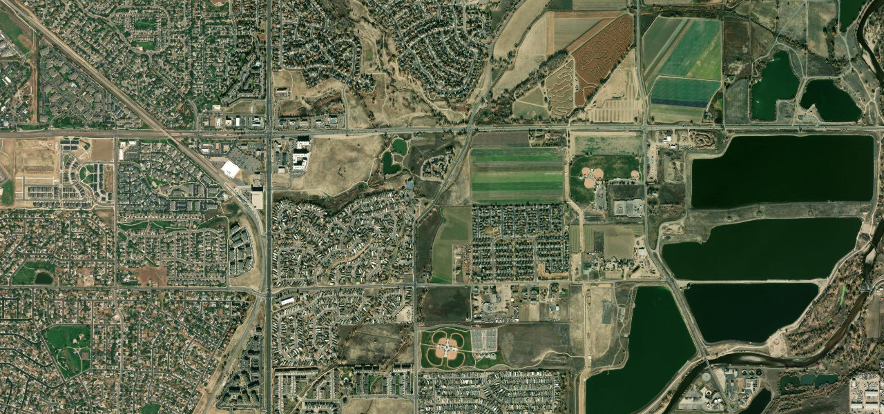Wider satellite context for Riverdale Road between East 100th and East 104th avenues; exact crash point unknown.
